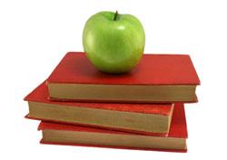 stock image of an apple on top of a stack of books