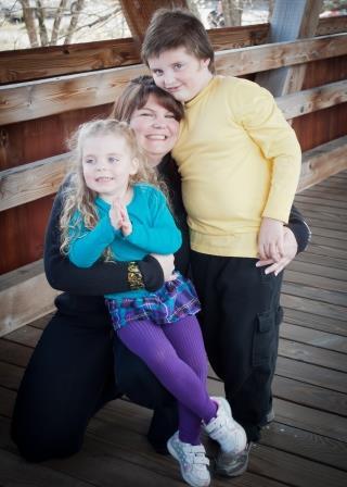 Logan, MJ, and their mom on a bridge